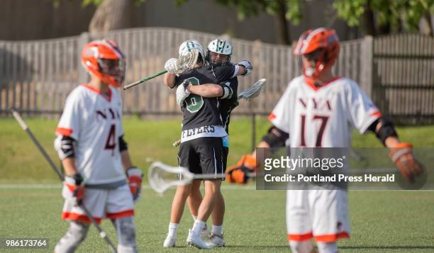 Waynflete junior Miles Lipton hugs senior Hank Duvall after a goal scored by Duvall during the Class C semifinal against North Yarmouth Academy....