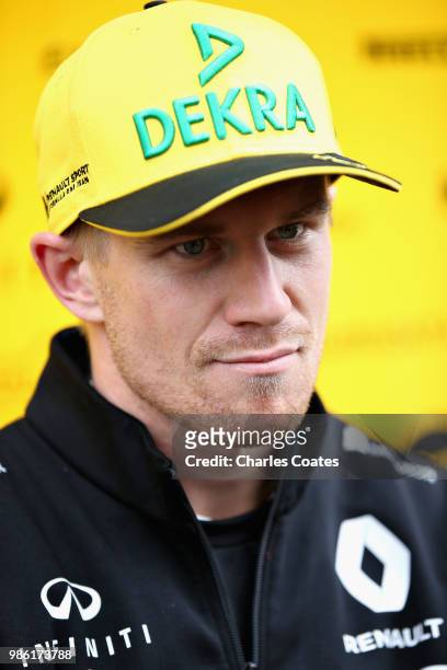 Nico Hulkenberg of Germany and Renault Sport F1 talks to the media in the Paddock during previews ahead of the Formula One Grand Prix of Austria at...