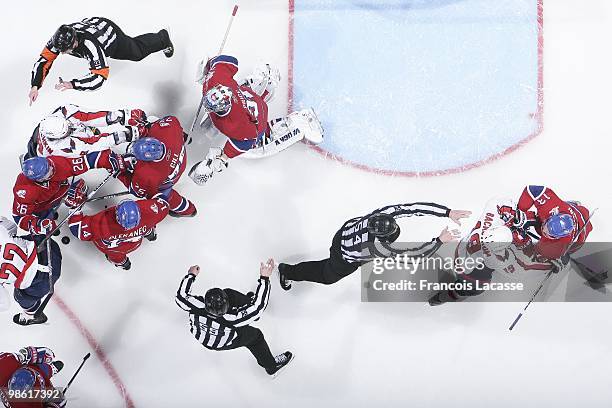 Hal Gill of Montreal Canadiens argues with Alex Ovechkin of the Washington Capitals in front of Carey Price of Montreal Canadiens in the Game Three...