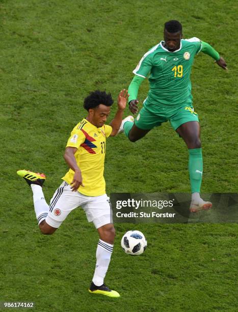 Juan Cuadrado of Colombia is challenged by Mbaye Niang of Senegal during the 2018 FIFA World Cup Russia group H match between Senegal and Colombia at...
