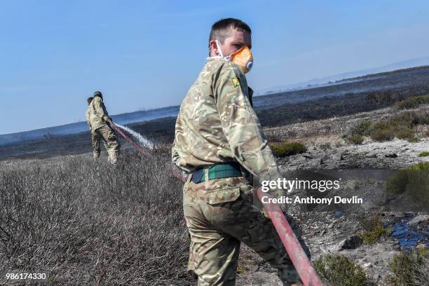 Soldiers from 4th Battalion Royal Regiment Scotland tackle wildfires near Swineshaw reservoir in Stalybridge on June 28, 2018 in Stalybridge,...