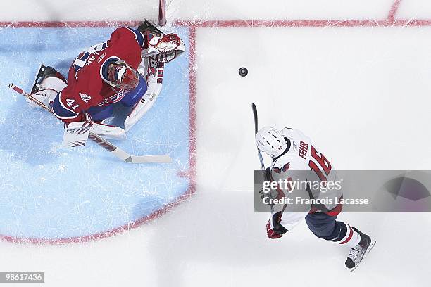 Eric Fehr of the Washington Capitals takes a shot on goalie Jaroslav Halak of Montreal Canadiens in the Game Three of the Eastern Conference...