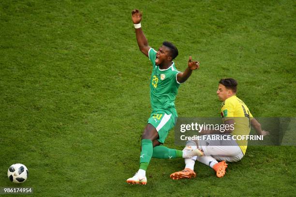 Senegal's forward Keita Balde reacts as he vies for the ball with Colombia's defender Santiago Arias during the Russia 2018 World Cup Group H...
