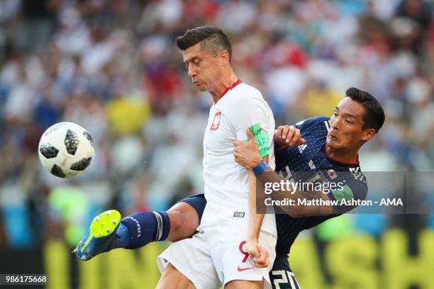 Tomoaki Makino of Japan battles for the ball with Robert Lewandowski of Poland during the 2018 FIFA World Cup Russia group H match between Japan and...