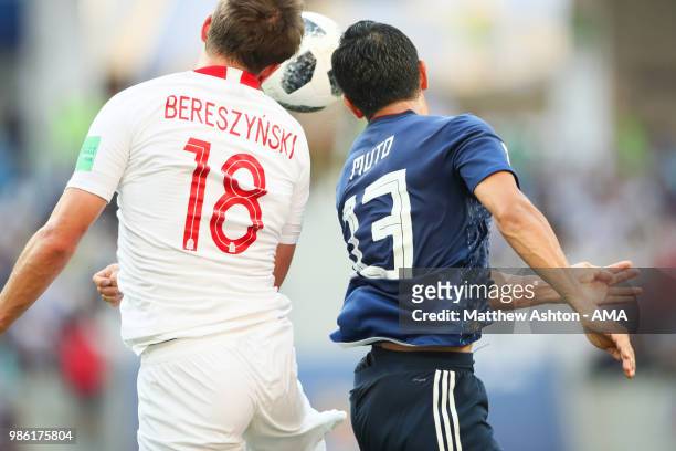Bartosz Bereszynski of Poland competes with Yoshinori Muto of Japan during the 2018 FIFA World Cup Russia group H match between Japan and Poland at...