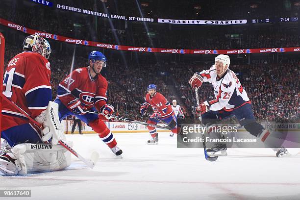 Jason Chimera of the Washington Capitals takes a shot on goalie Jaroslav Halak of Montreal Canadiens in the Game Three of the Eastern Conference...
