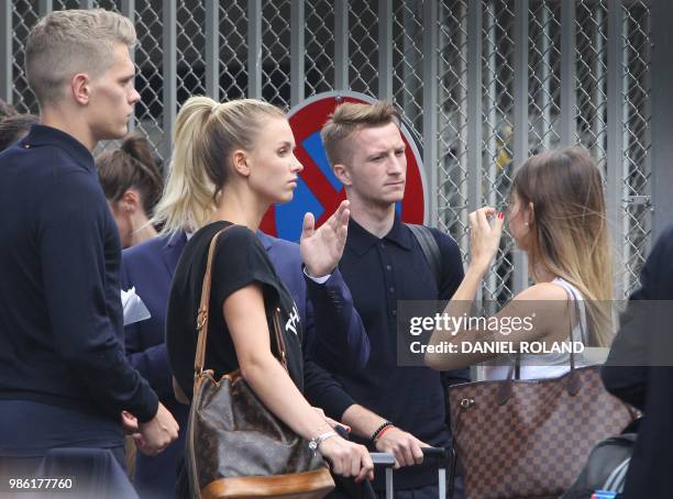 Germany's forward Marco Reus arrives at Frankfurt international airport on June 28 after flying back from Moscow following the German national...