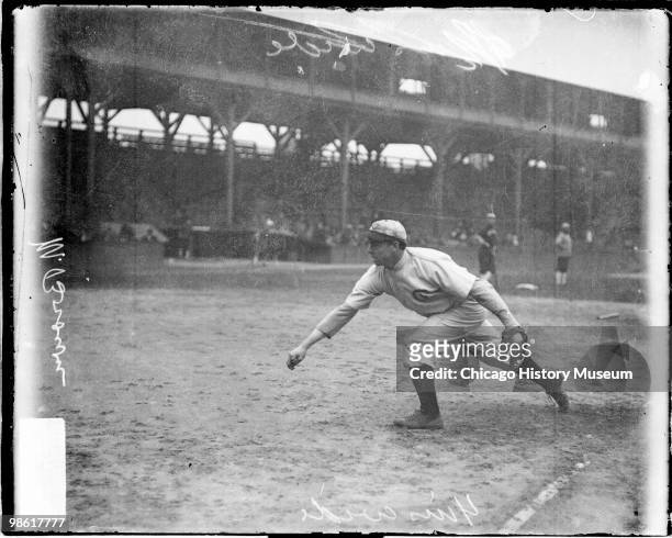 Informal full-length portrait of Hall of Fame baseball player Mordecai "Three Finger" Brown of the National League's Chicago Cubs, following through...