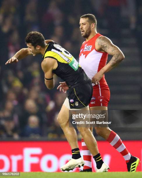 Lance Franklin of the Swans strikes Alex Rance of the Tigers during the round 15 AFL match between the Richmond Tigers and the Sydney Swans at Etihad...
