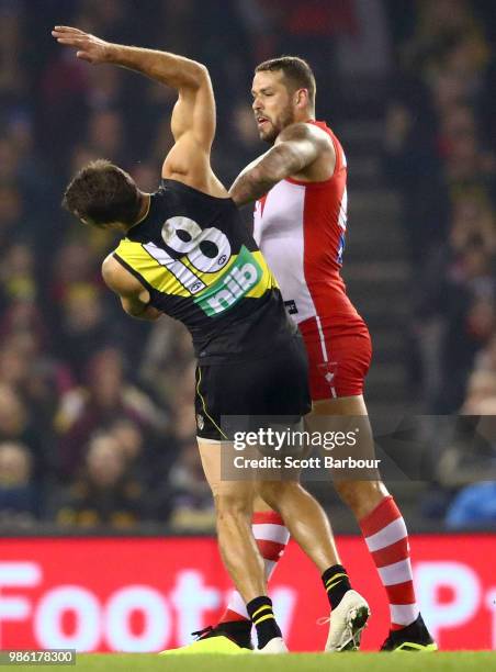 Lance Franklin of the Swans strikes Alex Rance of the Tigers during the round 15 AFL match between the Richmond Tigers and the Sydney Swans at Etihad...