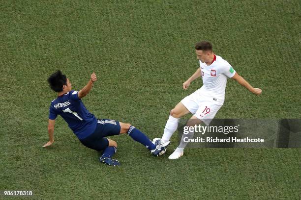 Gaku Shibasaki of Japan tackles Piotr Zielinski of Poland during the 2018 FIFA World Cup Russia group H match between Japan and Poland at Volgograd...