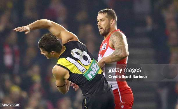 Lance Franklin of the Swans strikes Alex Rance of the Tigers during the round 15 AFL match between the Richmond Tigers and the Sydney Swans at Etihad...