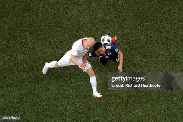 Rafal Kurzawa of Poland wins a header over Shinji Okazaki of Japan during the 2018 FIFA World Cup Russia group H match between Japan and Poland at...