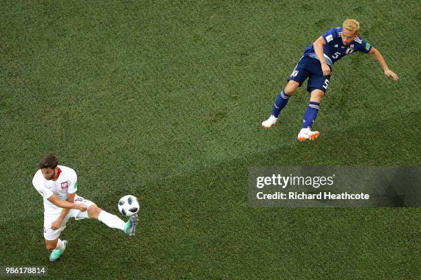 Bartosz Bereszynski of Poland tries to block a cross from Yuto Nagatomo of Japan during the 2018 FIFA World Cup Russia group H match between Japan...