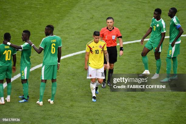 Colombia's midfielder James Rodriguez reacts as he leaves the football pitch due to an injury during the Russia 2018 World Cup Group H football match...