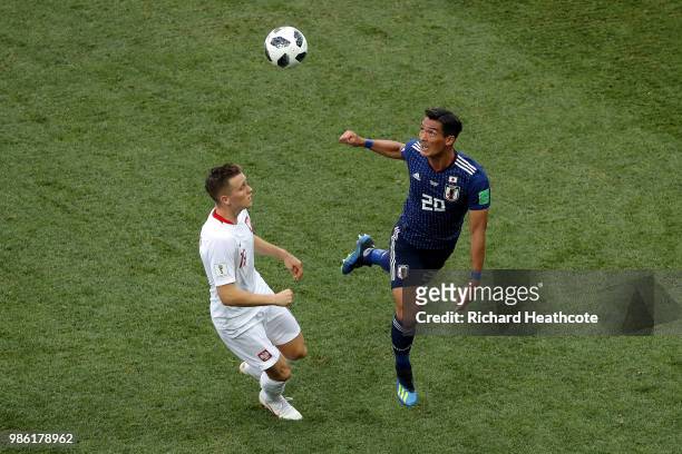 Tomoaki Makino of Japan wins a header over Piotr Zielinski of Poland during the 2018 FIFA World Cup Russia group H match between Japan and Poland at...