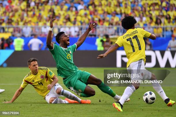 Senegal's forward Keita Balde reacts as he is fouled by Colombia's defender Santiago Arias next to Colombia's forward Juan Cuadrado during the Russia...