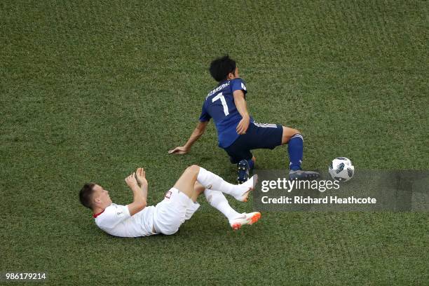 Piotr Zielinski of Poland tackles Gaku Shibasaki of Japan during the 2018 FIFA World Cup Russia group H match between Japan and Poland at Volgograd...