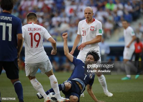 Gaku Shibasaki of Japan in action against Rafal Kurzawa of Poland during the 2018 FIFA World Cup Russia Group H match between Japan and Poland at the...