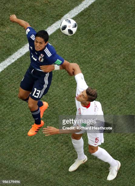 Yoshinori Muto of Japan and Jan Bednarek of Poland compete for the ball during the 2018 FIFA World Cup Russia group H match between Japan and Poland...