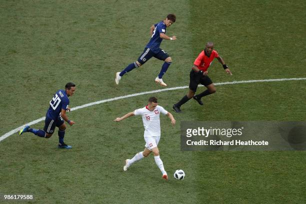 Piotr Zielinski of Poland is challenged by Tomoaki Makino of Japan during the 2018 FIFA World Cup Russia group H match between Japan and Poland at...