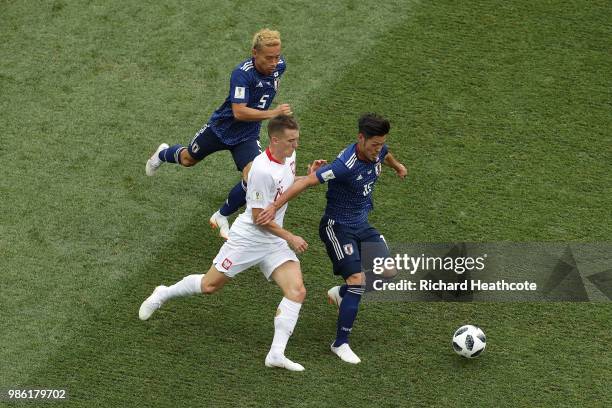 Piotr Zielinski of Poland battles for the ball with Yuto Nagatomo and Hotaru Yamaguchi of Japan during the 2018 FIFA World Cup Russia group H match...