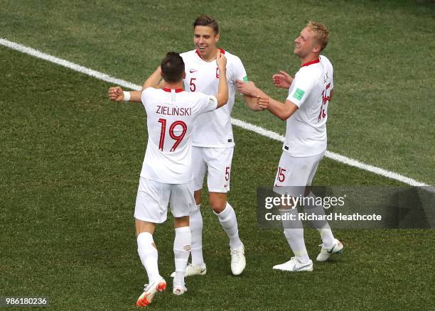 Jan Bednarek of Poland celebrates with teammates Piotr Zielinski and Kamil Glik after scoring his team's first goal during the 2018 FIFA World Cup...