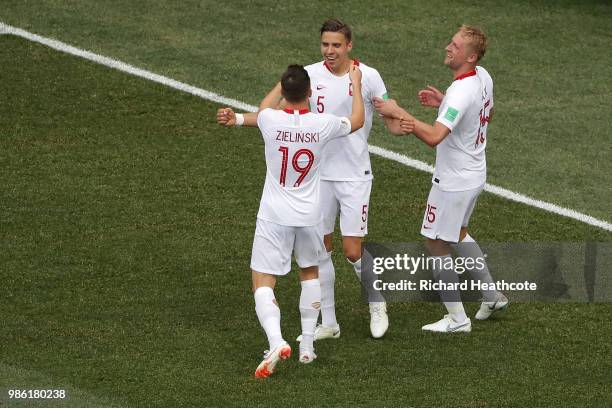 Jan Bednarek of Poland celebrates with teammates Piotr Zielinski and Kamil Glik after scoring his team's first goal during the 2018 FIFA World Cup...