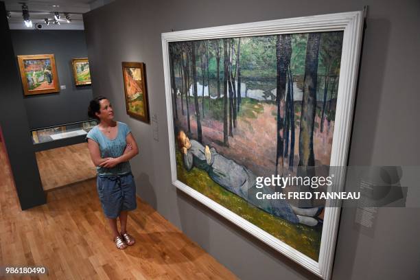 Person looks at "Madeleine au bois d'Amour" oil on canvas by French painter Emile Bernard during the exhibition "Le Talisman by Paul Serusier, Une...