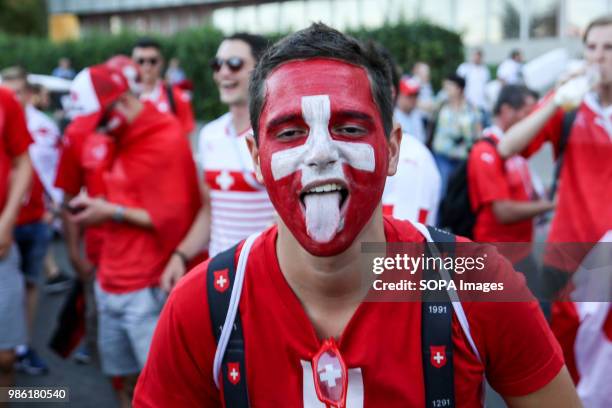 This Swiss fan with a painted faces was among hundreds of Swiss football fans who walked the streets in the city center before the game between...