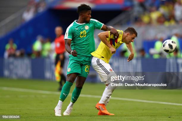 Santiago Arias of Colombia and Keita Balde of Senegal compete for the ball during the 2018 FIFA World Cup Russia group H match between Senegal and...