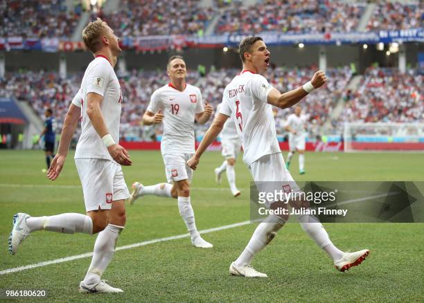 Jan Bednarek of Poland celebrates with teammates Piotr Zielinski and Kamil Glik after scoring his team's first goal during the 2018 FIFA World Cup...