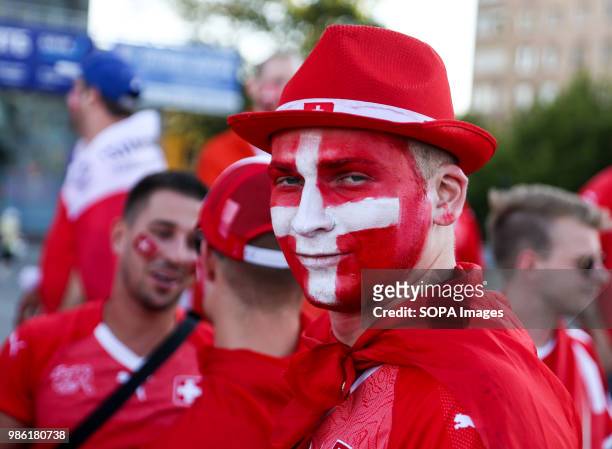 This Swiss fan with a painted faces was among hundreds of Swiss football fans who walked the streets in the city center before the game between...