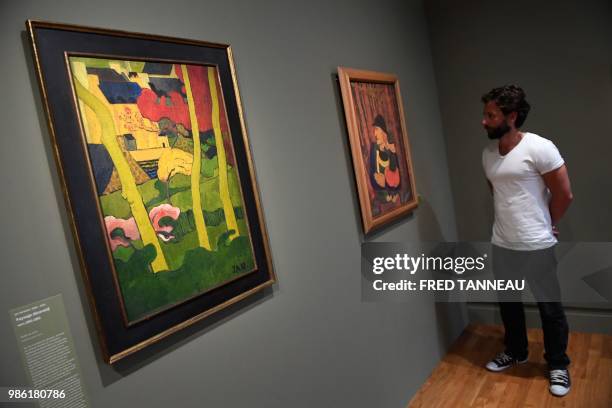 Person looks at "Paysage decoratif ", 1891-92, oil on canvas by French painter Jan Verkade during the exhibition "Le Talisman by Paul Serusier, Une...