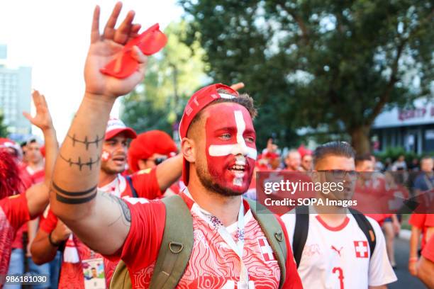 These Swiss fans with painted faces were among hundreds of Swiss football fans who walked the streets in the city center before the game between...