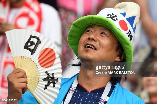Japan's fan gestures during the Russia 2018 World Cup Group H football match between Japan and Poland at the Volgograd Arena in Volgograd on June 28,...
