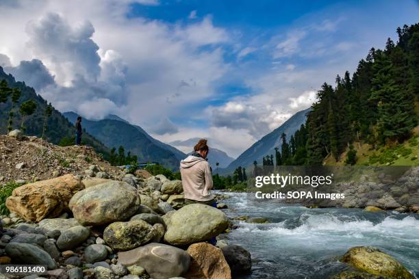 View of Pahalgam along with the river lidder flowing in the middle on a sunny day. Pahalgam is a hill station in the Ananthnag District of Jammu and...