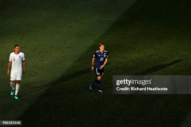 Artur Jedrzejczyk of Poland and Gotoku Sakai of Japan look on during the 2018 FIFA World Cup Russia group H match between Japan and Poland at...