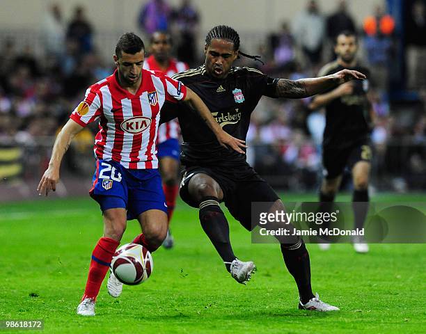 Simao of Atletico Madrid holds off Glen Johnson of Liverpool during the UEFA Europa League Semi Final first leg match between Atletico Madrid and...