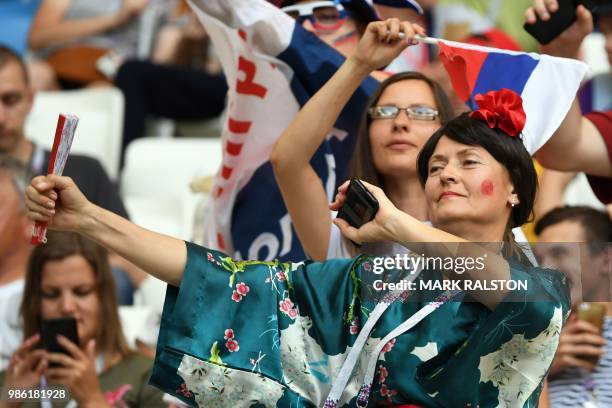 Japan's fan wearing a kimono gestures during the Russia 2018 World Cup Group H football match between Japan and Poland at the Volgograd Arena in...