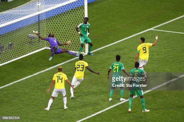 Yerry Mina of Colombia scores his team's first goal past Khadim Ndiaye of Senegal as Radamel Falcao, Davinson Sanchez start to celebrate during the...