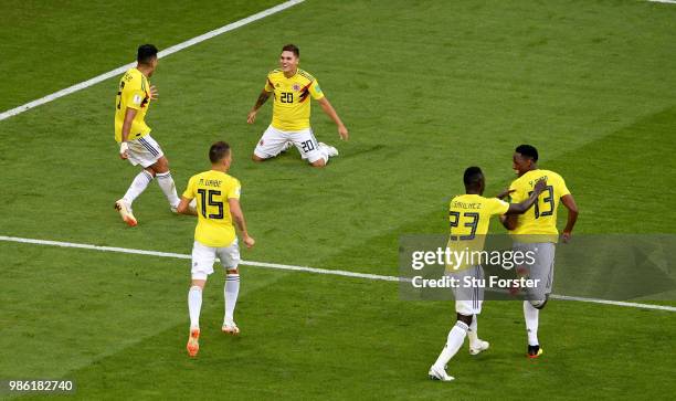 Yerry Mina of Colombia celebrates with teammates after scoring his team's first goal during the 2018 FIFA World Cup Russia group H match between...
