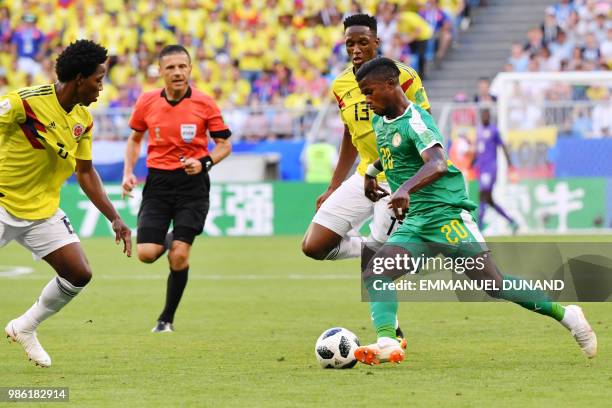 Senegal's forward Keita Balde challenges Colombia's defender Yerry Mina and Senegal's defender Salif Sane during the Russia 2018 World Cup Group H...