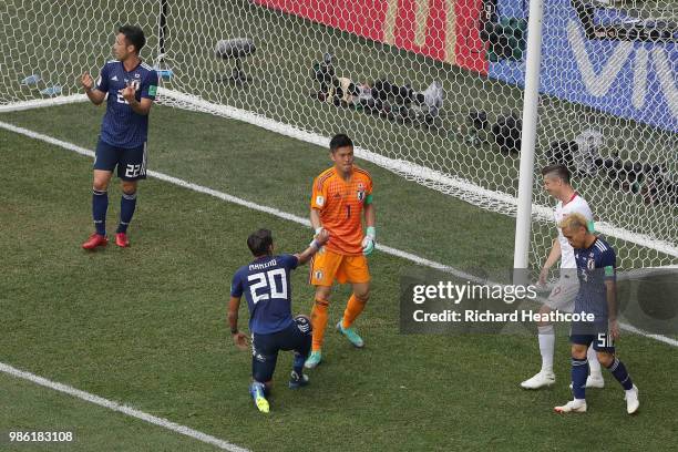 Tomoaki Makino of Japan is congratulated from teammate Eiji Kawashima of Japan during the 2018 FIFA World Cup Russia group H match between Japan and...