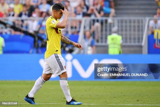 Colombia's midfielder James Rodriguez reacts as he walks off the pitch after getting injured during the Russia 2018 World Cup Group H football match...