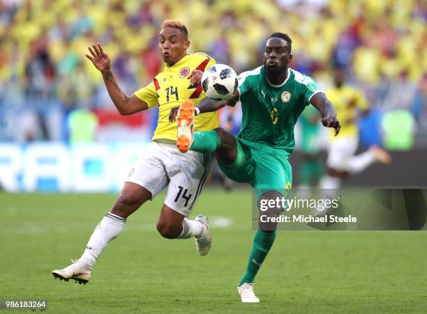Luis Muriel of Colombia battles for possession with Salif Sane of Senegal during the 2018 FIFA World Cup Russia group H match between Senegal and...