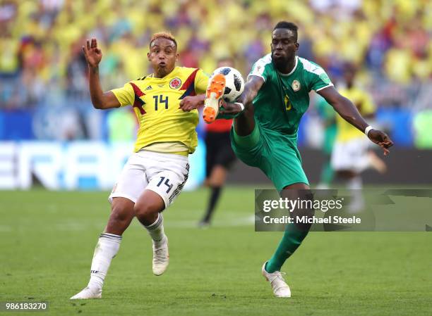 Luis Muriel of Colombia battles for possession with Salif Sane of Senegal during the 2018 FIFA World Cup Russia group H match between Senegal and...