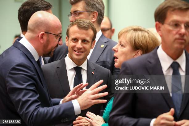 Belgium's Prime Minister Charles Michel, France's President Emmanuel Macron and Germany's Chancellor Angela Merkel speak during an European Union...