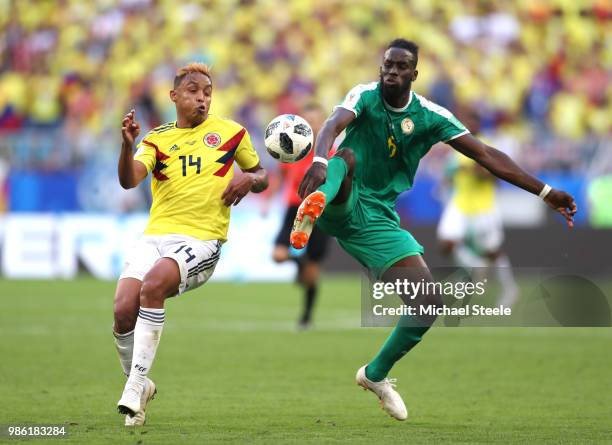 Luis Muriel of Colombia battles for possession with Salif Sane of Senegal during the 2018 FIFA World Cup Russia group H match between Senegal and...