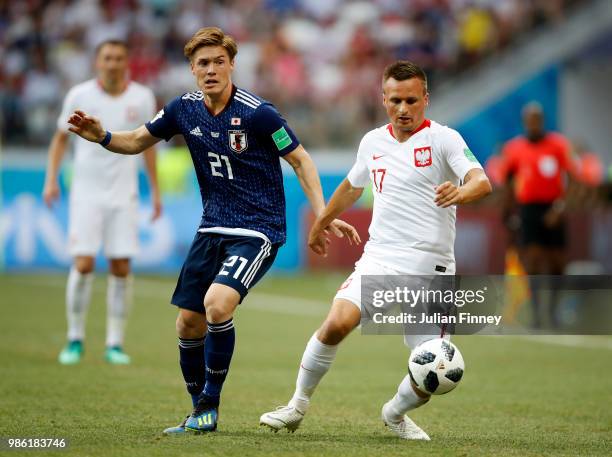 Gotoku Sakai of Japan challenges Slawomir Peszko of Poland during the 2018 FIFA World Cup Russia group H match between Japan and Poland at Volgograd...